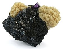 Кристаллизованные блестящие черные кристаллы сфалерита, в которых находятся две розетки светло-коричневого барита, а также одного кристалла флюорита лавандового цвета.
